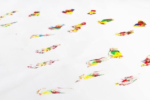 many colorful footprints of small child on floor