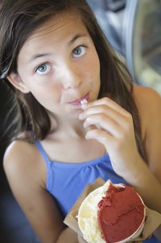 Pretty Young Girl Enjoying Her Cup of Gelato.