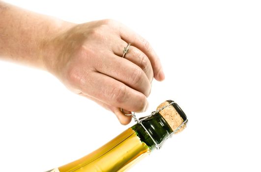 Female hand opening a bottle of champagne a new years eve