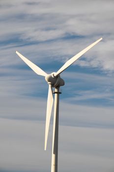 Eletric Power Generator Wind Turbine over a Cloudy Sky