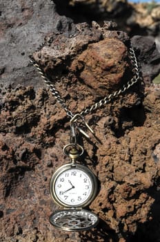 Time Concept Classic Vintage Pocket Clock on the Volcanic Rocks
