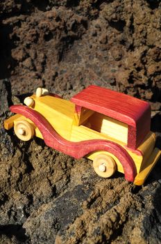 Transportation Concept Wooden Toy Car on the Rocks