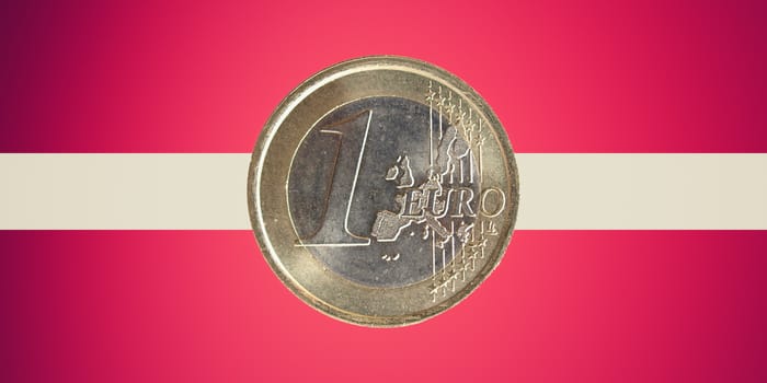 One Euro coin over the flag of Latvia, a country in the Baltic region of Northern Europe which adopted the Euro currency on January 1, 2014