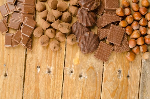 Nuts and chcolate displayed on a rustic wooden background