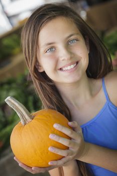 Pretty Young Girl Having Fun with the Pumpkins at the Market.