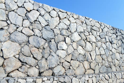 Stone wall background and texture with blue sky