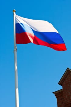 Russian flag on  background of blue sky