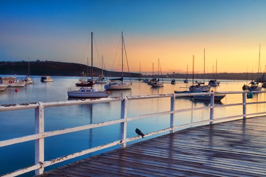 Boats, yachts and catamarans bob and tug at their moorings at sunrise, dreaming of places yet unvisited.