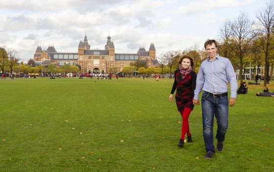 Outdoor happy couple in love, Museum Plein, autumn Amsterdam background