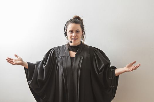 thirty something brunette woman dress as a preacher with her arm opened