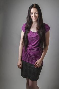 young woman with long black hair and a purple shirt