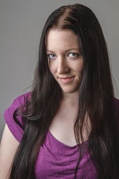 portrait of a young woman with long black hair and a purple shirt