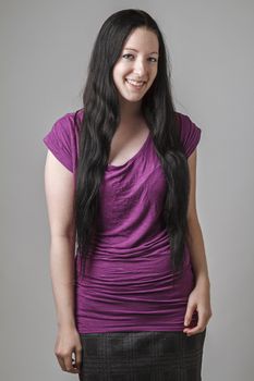 young woman with long black hair and a purple shirt