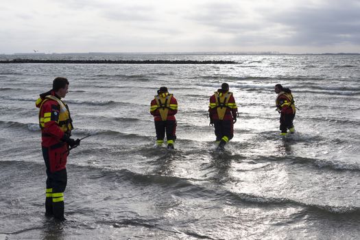 rescue divers chechiing the beach for the new years dip in Holland