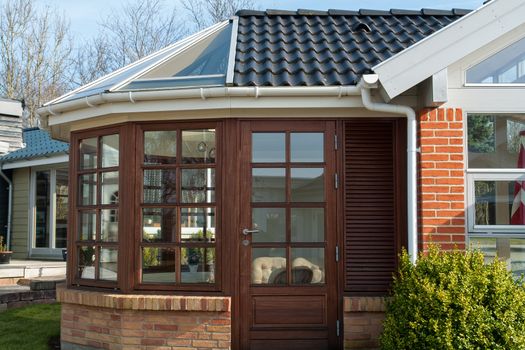 Modern design conservatory made of wooden frame and glass