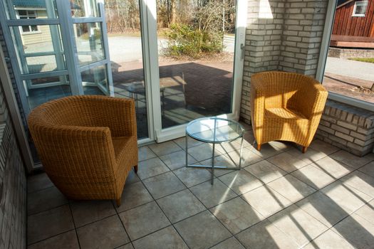 Country style seating corner inside a modern conservatory