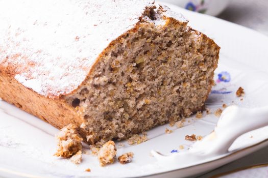 Walnut cake, piece on the plate, close up