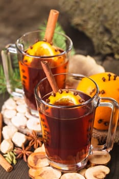 A mulled wine in the glass cup on wooden background