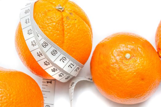 Measuring tape around a oranges isolated on white background