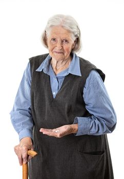 Senior woman holding medications over white background