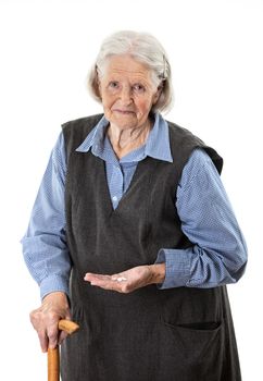 Senior woman holding medications over white background