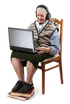 Senior woman using laptop computer isolated on white