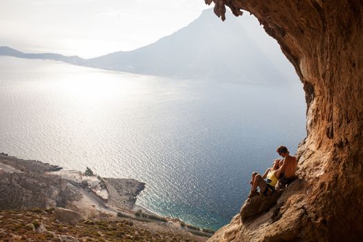 Young couple of rock climbers having a rest. Kalymnos Island, Greece.