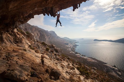 Rock climber climbing at the rock at sunset, Kalymnos Island, Greece