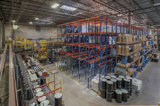 Products stacked on shelving in an industrial warehouse