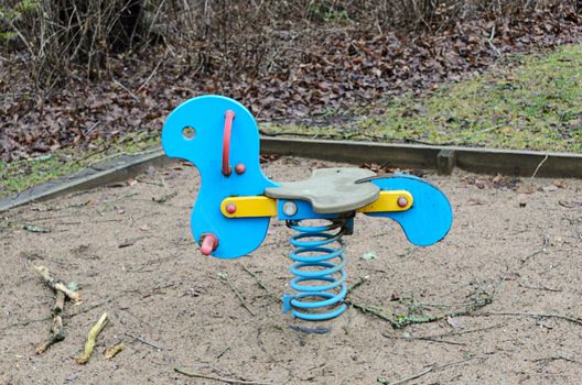  out toy rocking horse for the kids on playground in the woods