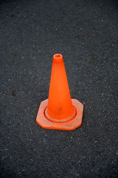 A close up shot of a safety cone on a road