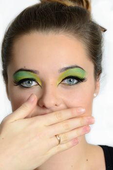 Close up portrait of young female model with blond hairs. Teenager from Poland, smiling face and colorful makeup.