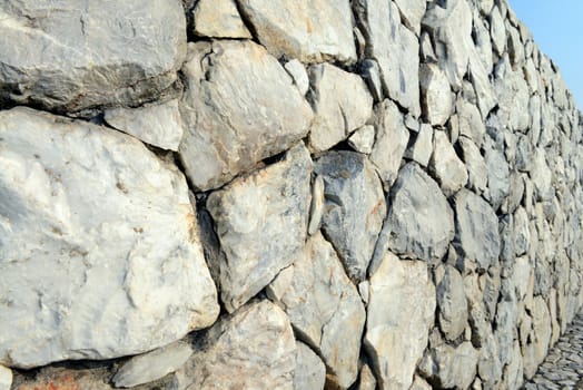 Stone wall background and texture with blue sky