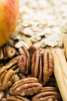 Ingredients for baking, pecans with cinnamon sticks and other ingredients for apple crumble