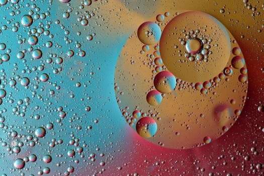 Abstract pattern of colored oil bubles on water