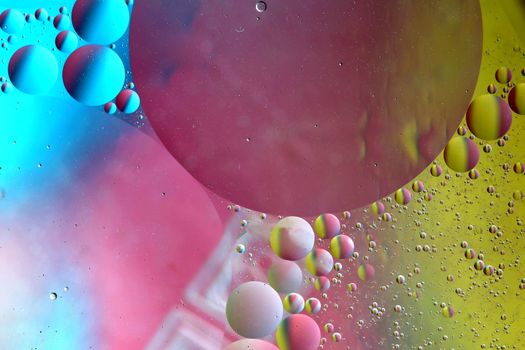 Abstract pattern of colored oil bubles on water