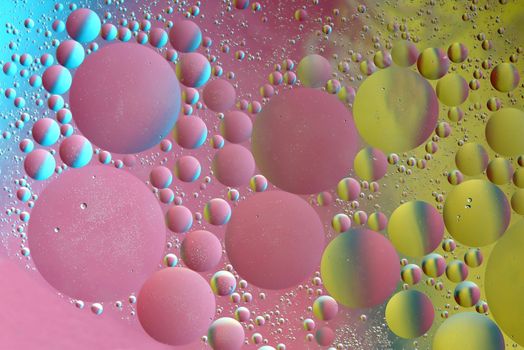 Abstract pattern of colored oil bubles on water