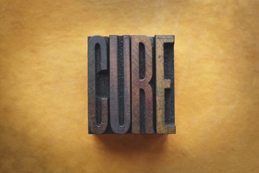 The word CURE written in vintage letterpress type.