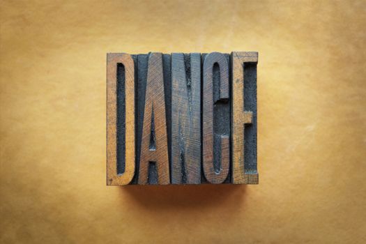 The word DANCE written in vintage letterpress type.