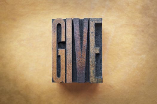 The word GIVE written in vintage letterpress type.