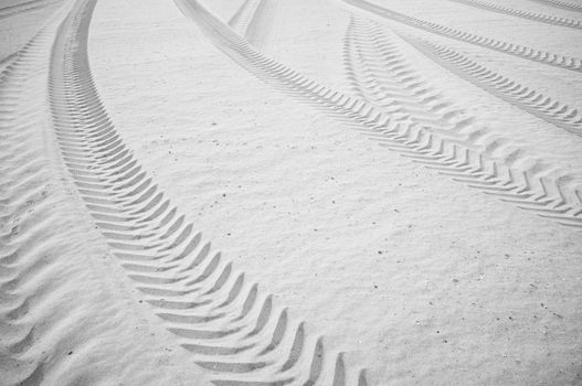 Many curved tyre track printed on  sandy soil