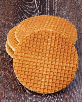 Stack of Delicious Dutch Waffles isolated on Dark Wooden background