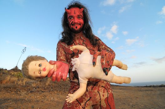 Latin American Man with Long Hairs Masked as a Devil in the Desert