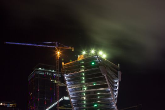 Top of ckyskraper in fog at night