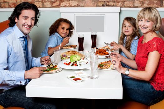 Family enjoying dinner outdoors on weekend