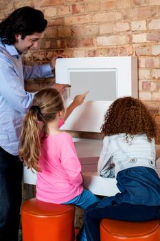 Man showing daughters how to order pizza online