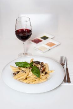 Delicious pasta served with sauces and red wine