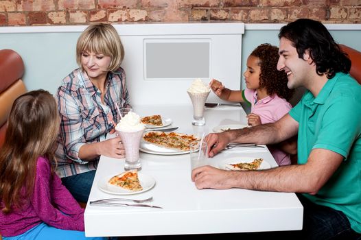 Family of four having great time in a restaurant