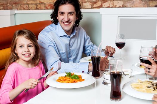 Father dining with his cute little daughter