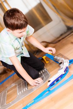 boy plays with toy train